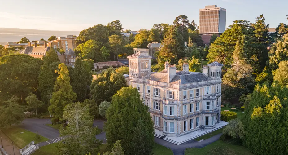 An aerial shot of Reed Hall and the surrounding gardens on Streatham Campus