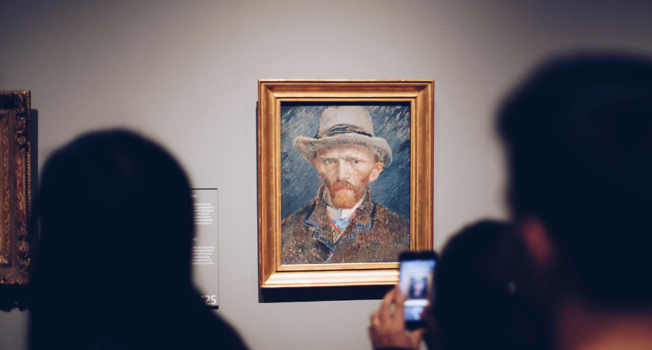 Two adults looking at a painting of Vincent van Gogh