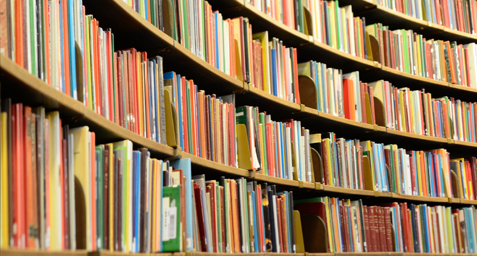 A row of books on shelves in a library