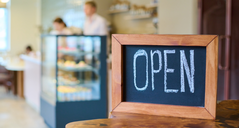 open sign on a blackboard in a coffee shop