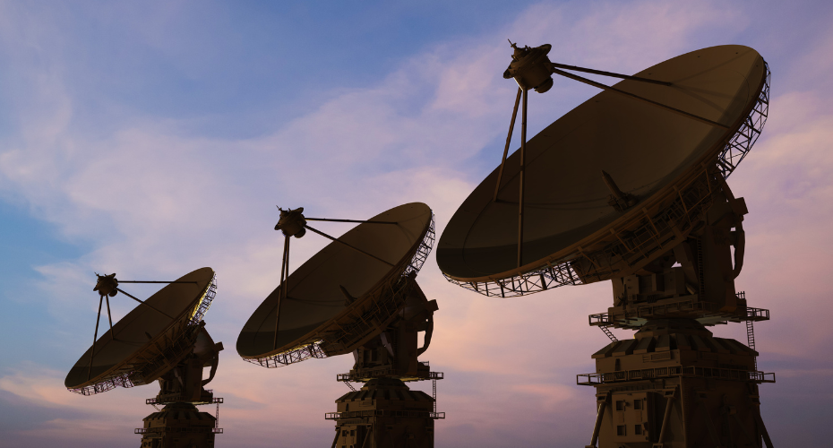 Satellite dishes in the desert at sunset