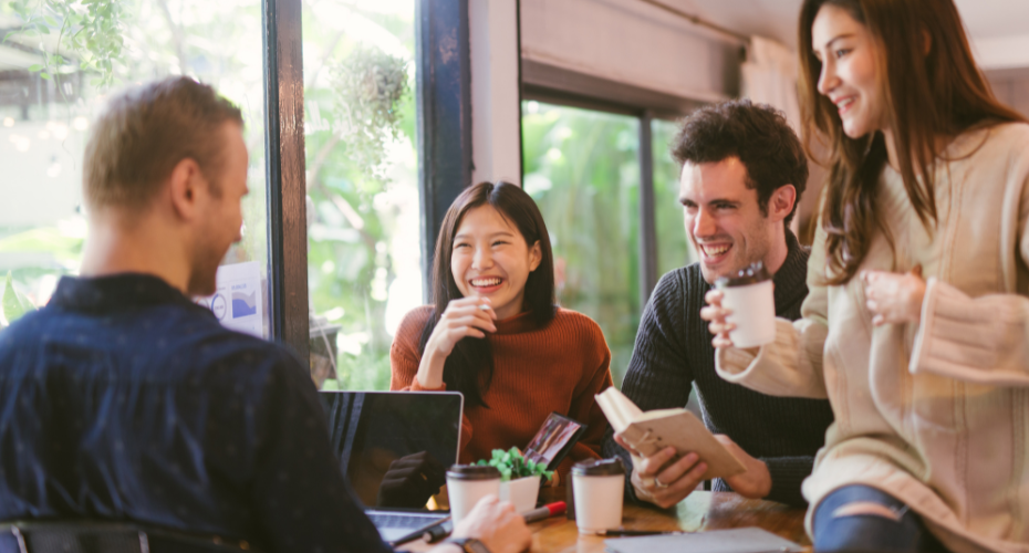 4 students chatting round a table