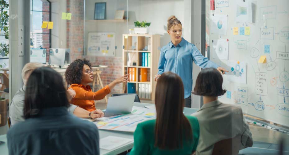 A woman presenting in a small meeting