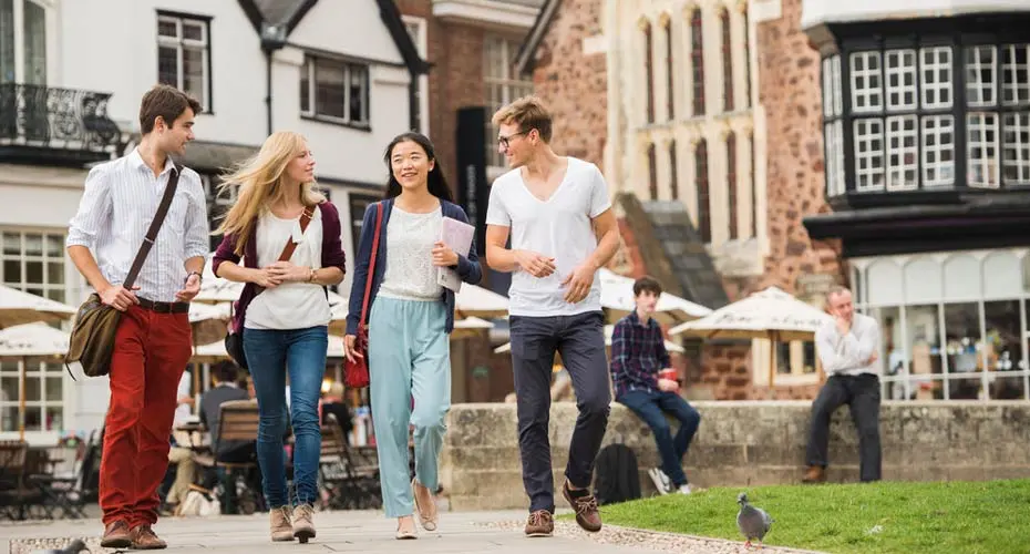 Students walking through Cathedral green, Exeter