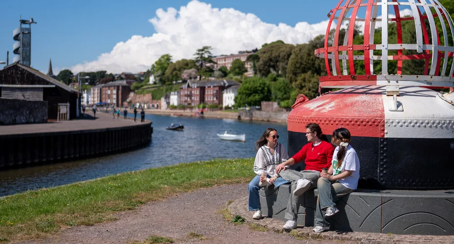 A group of Exeter students sat having a chat in the sunshine at the Quay.