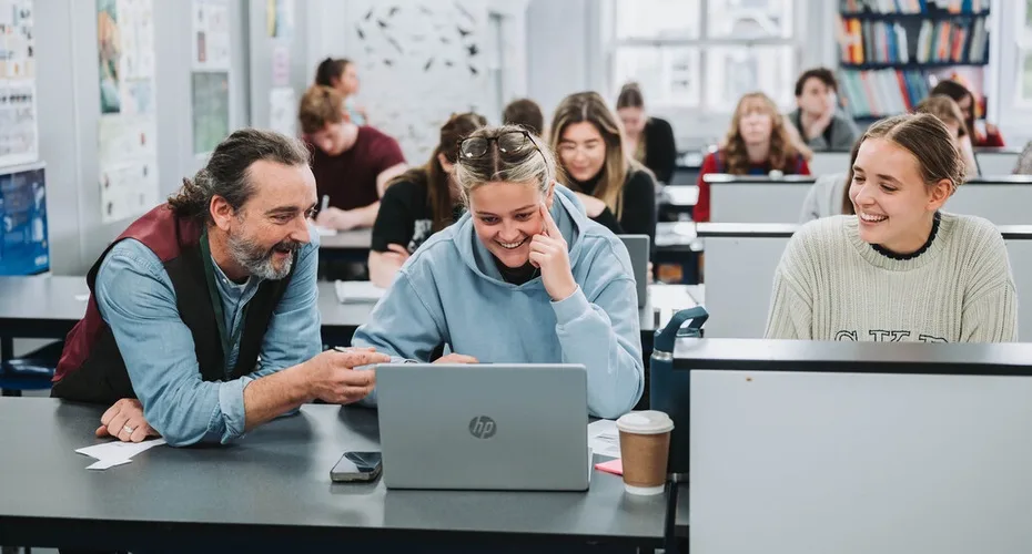 A member of staff discussing with a student during a science seminar on one of our PGCE programmes.