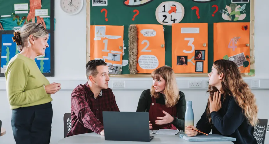PGCE students working and discussing in the communal / study area in Baring Court, St Luke's Campus.