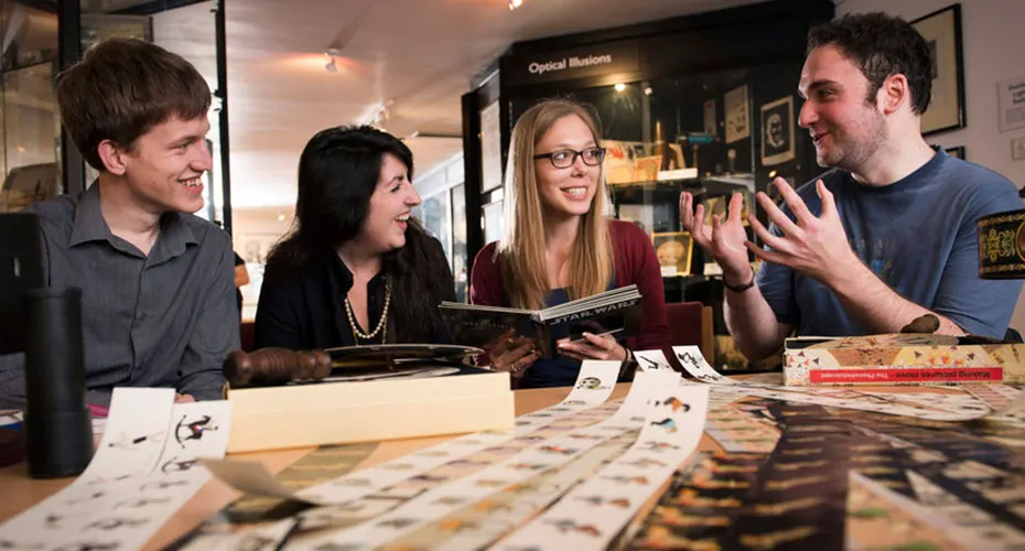 Film students discussing artefacts at the Bill Douglas Cinema Museum