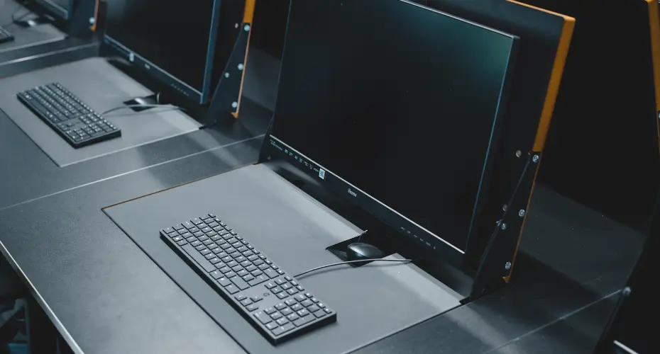 Close up of a fold down computer monitor with keyboard in the computer science lab