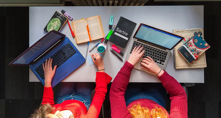 A pair of students studying together for their online degree programme