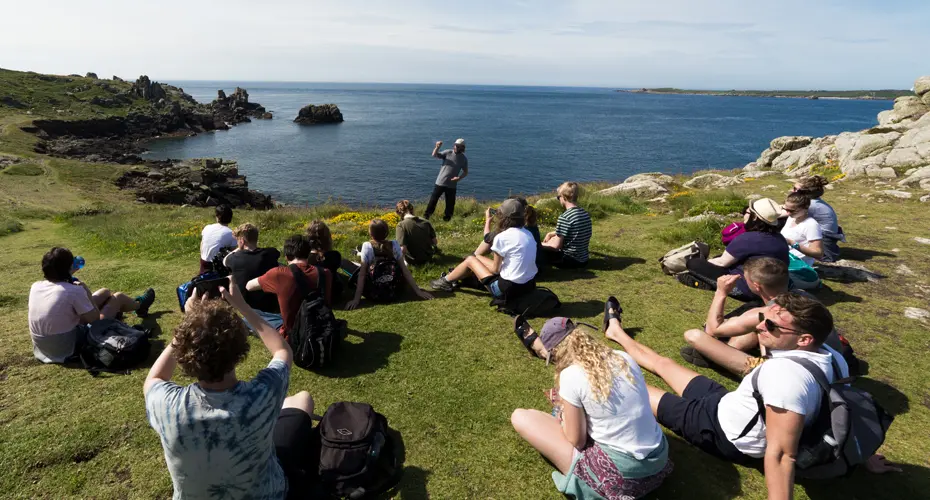 Student on cliff in Scilly islands