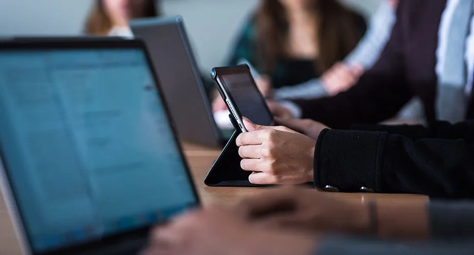 A group of people studying on their online university programme