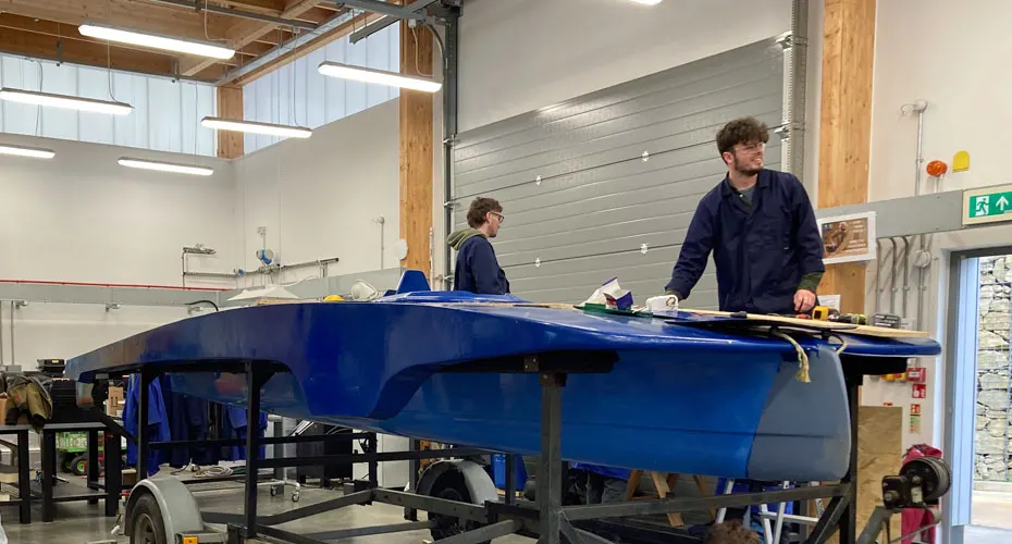 Students building a solar boat