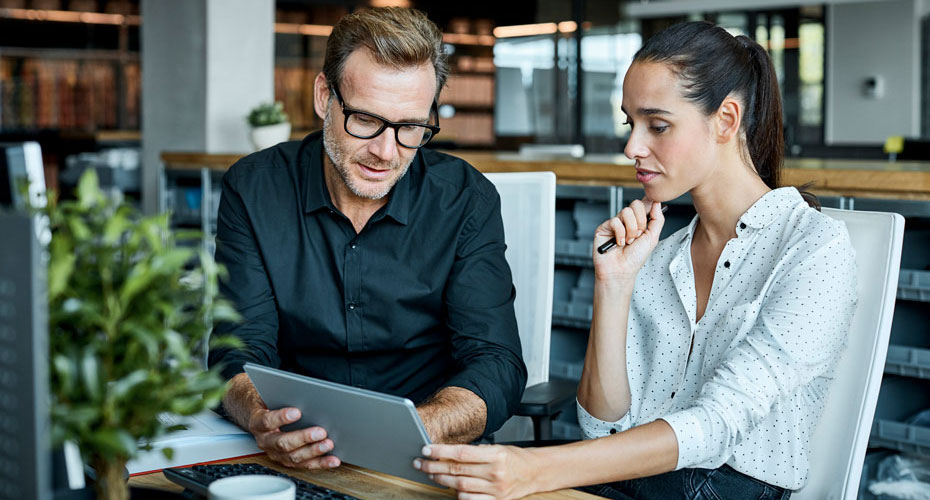 Two people looking at a laptop