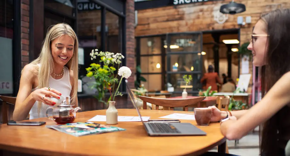 Two students enjoying a relaxed study session in Exeter city centre.