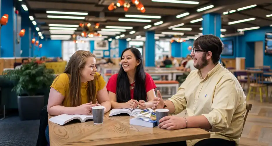 Students studying together in Cross Keys cafe over coffee