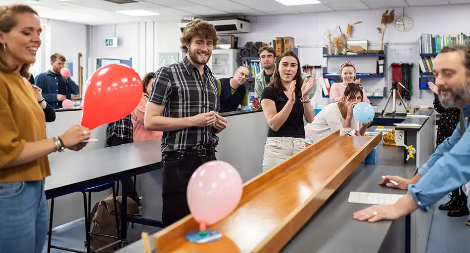 PGCE students undertaking an experiment involving balloons in a trainee science lesson