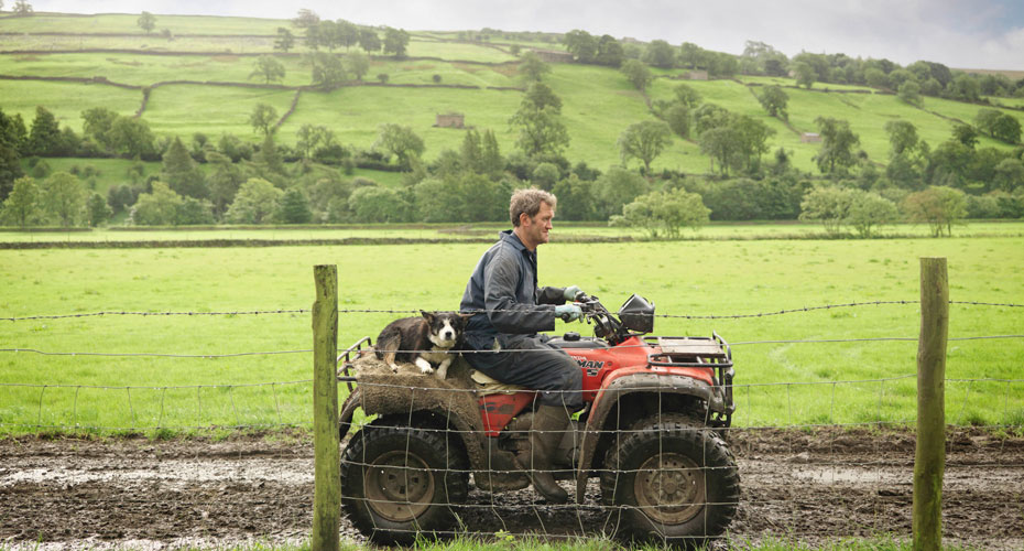 Farmer on quad bike with dog