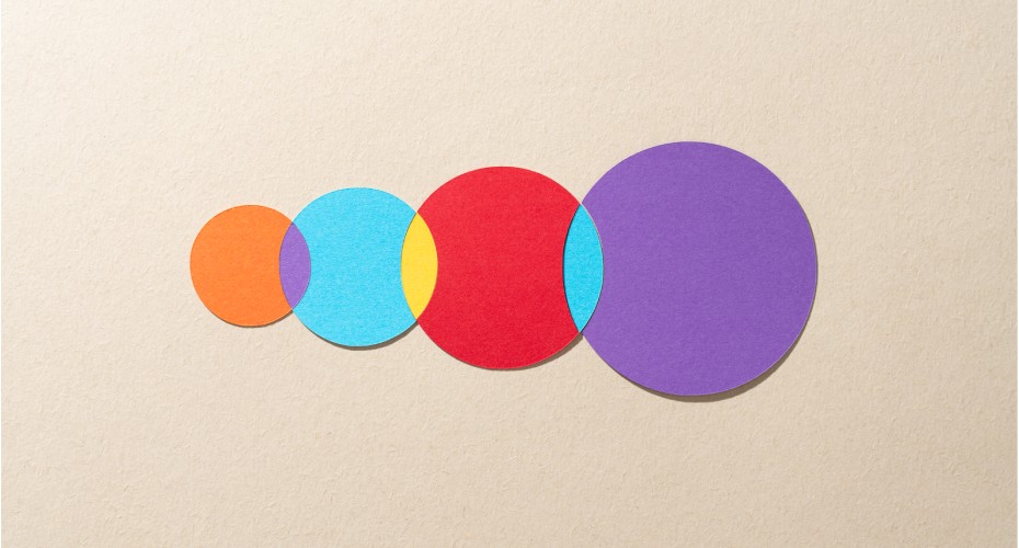 Paper Cut Craft Multi Colored Venn Diagram Composed of Four Crossing Circles on Beige Background Directly Above View.