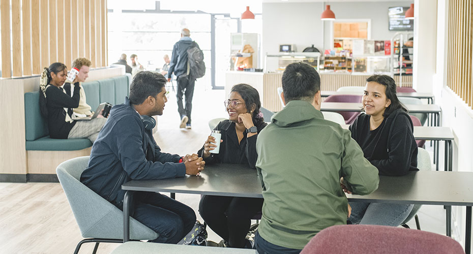 Students gathered in a vibrant campus area, showcasing academic life and community.