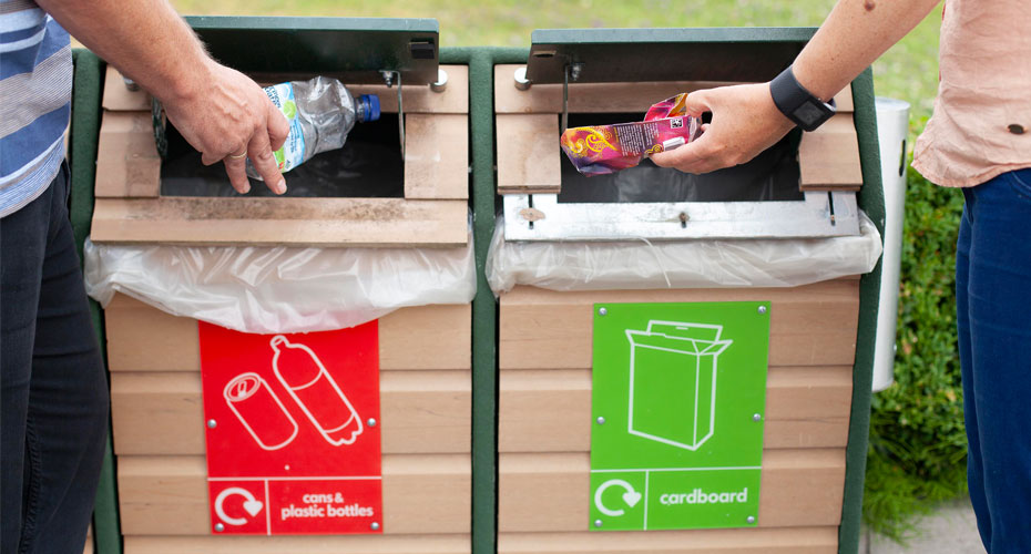 Students placing waste in recycling bin