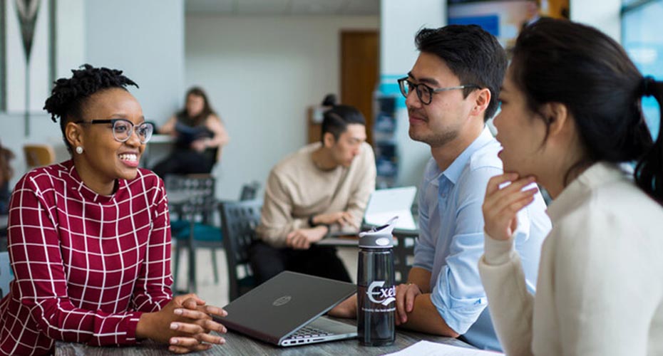 A group of Business School students studying together