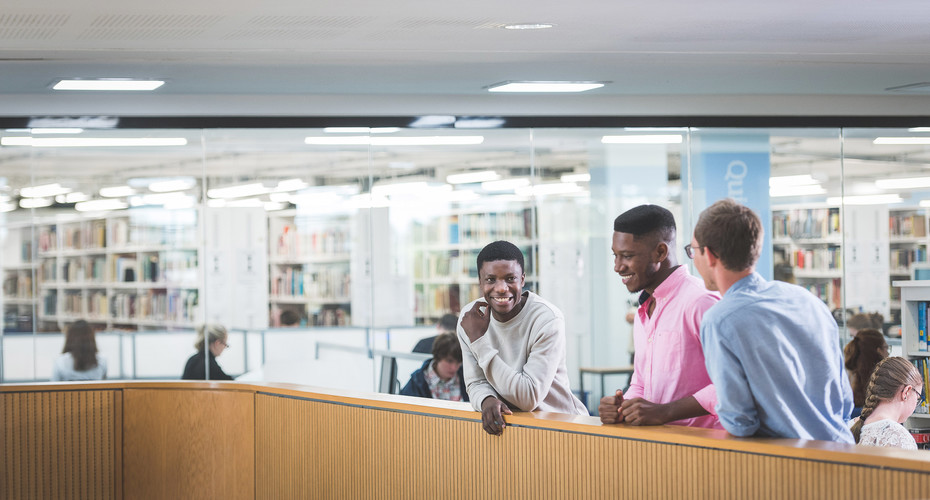 Students stood in library socialising