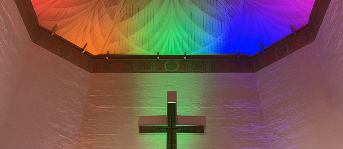 Ceiling over altar of Mary Harris Chapel lit with multicoloured lights.