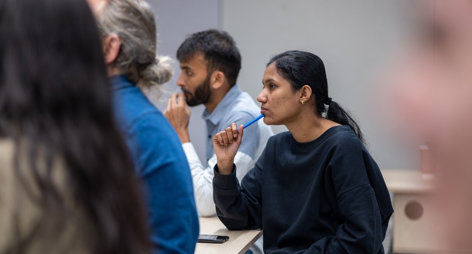 Digital Team members listening to a speaker