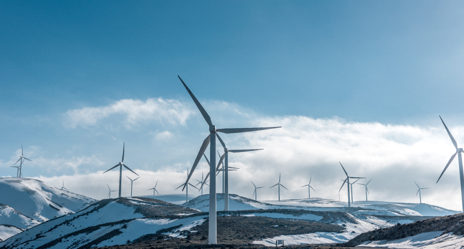 Clouds and snowy landscape with wind turbines