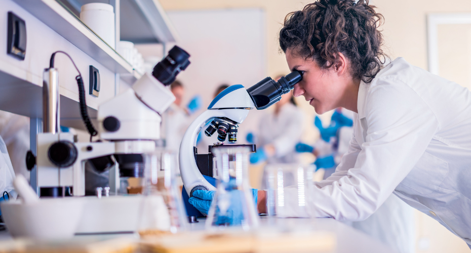 Scientist using microscope