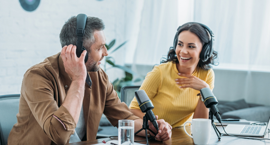 A man and a woman recording a podcast