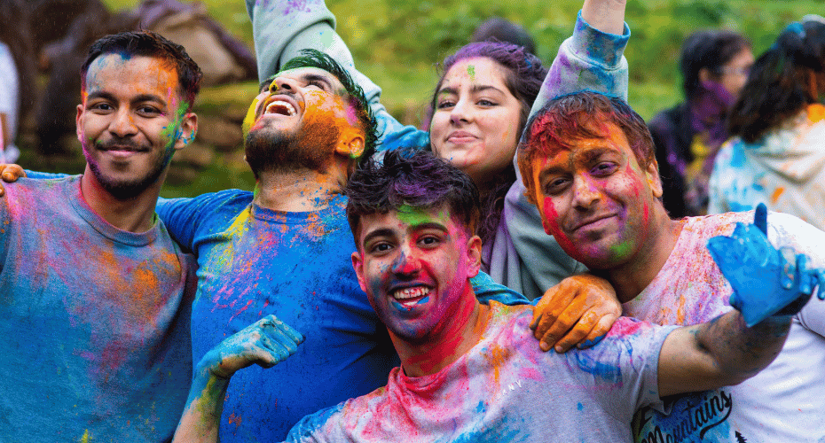 The SU Holi celebrations 2023, students with coloured powder on their faces.